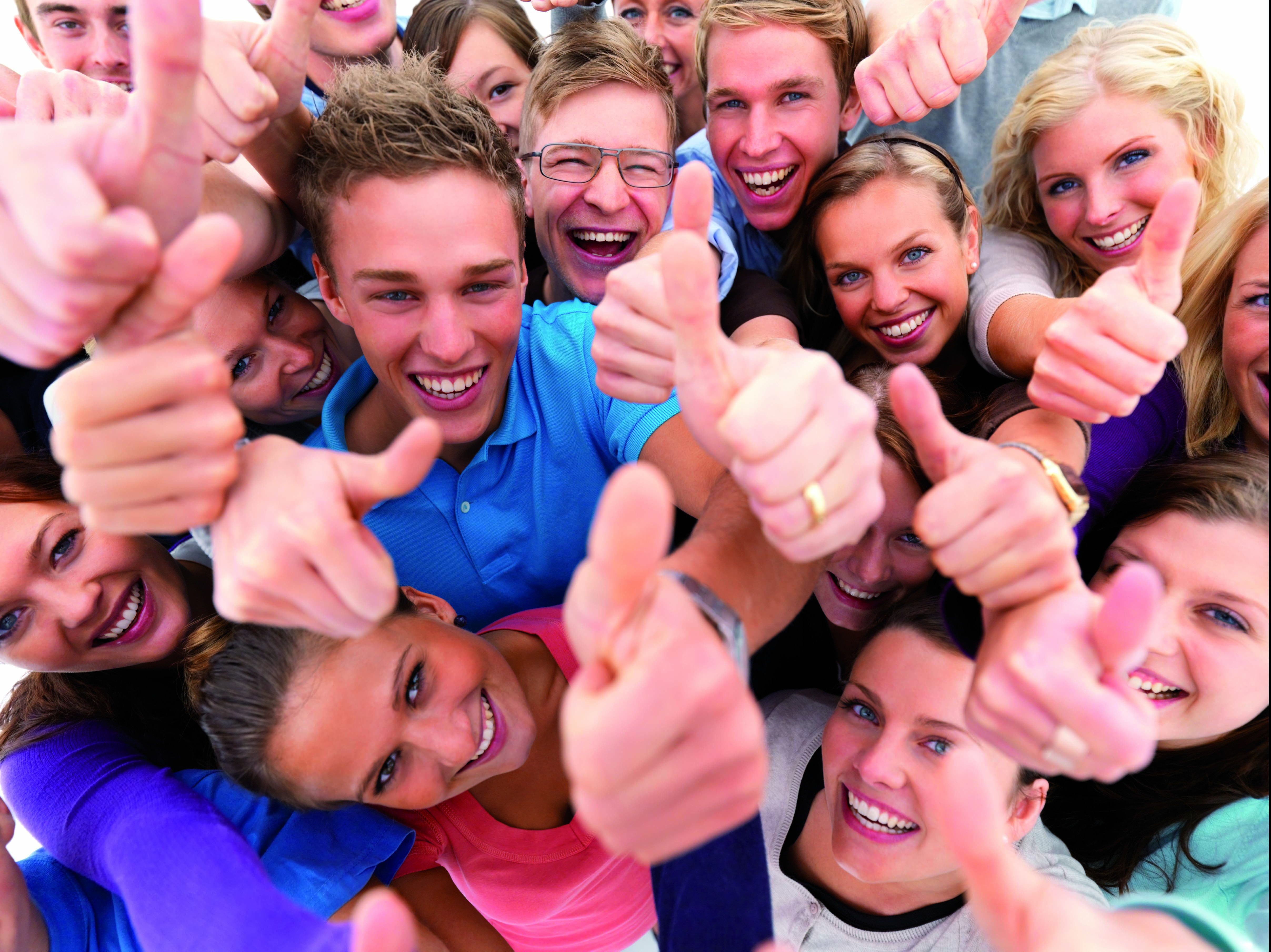 Top view portrait of men and women standing together and showing thumbsup sign